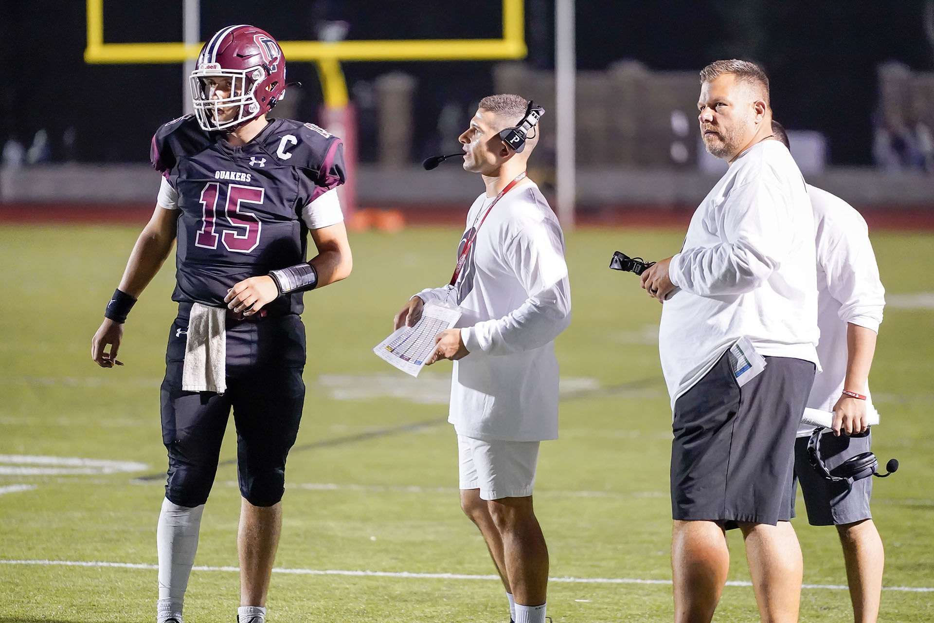 Coaches talking to the QB during a timeout Coaches talking to the QB during a timeout