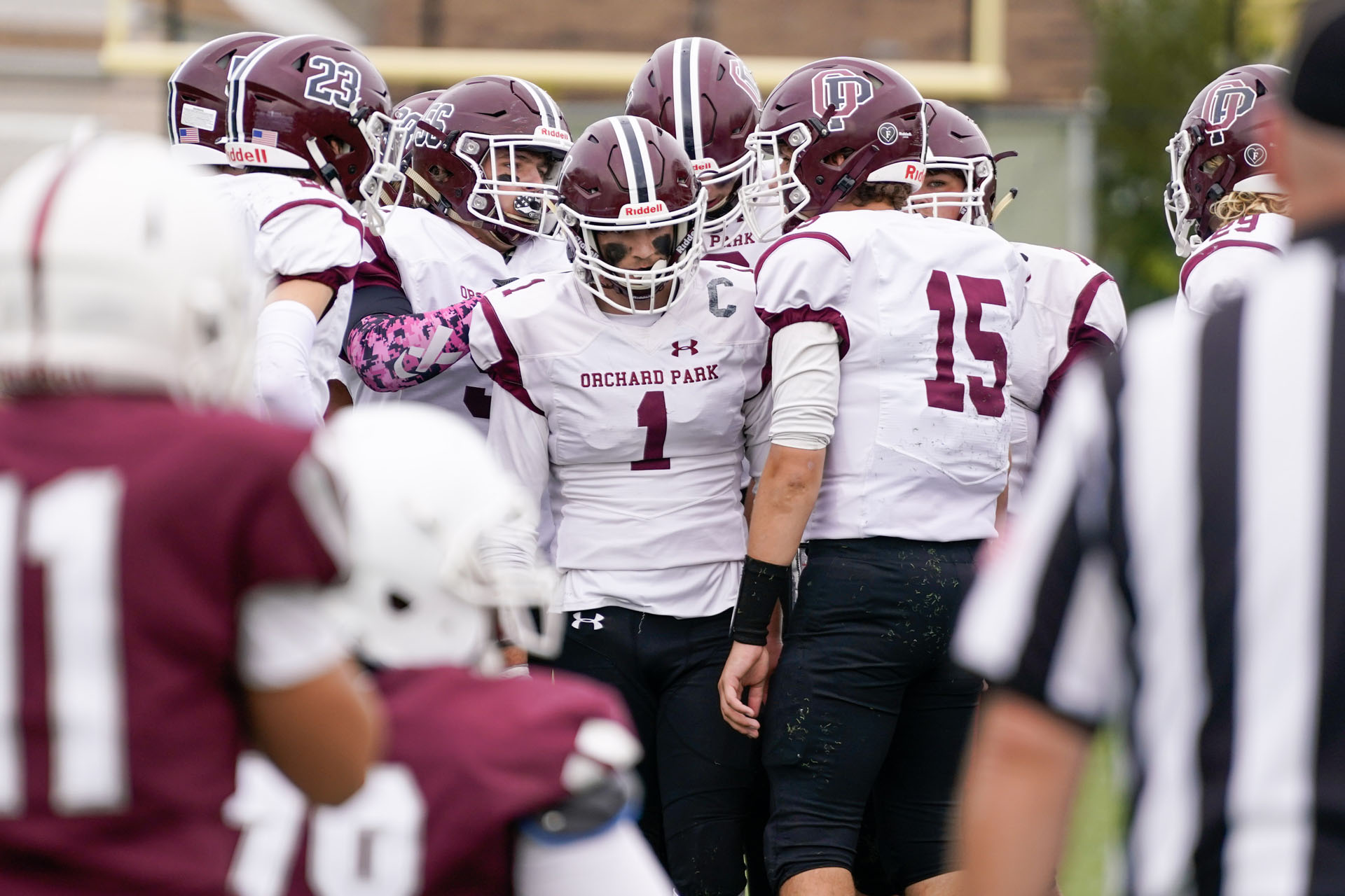 The QB calling the play in the huddle The QB calling the play in the huddle