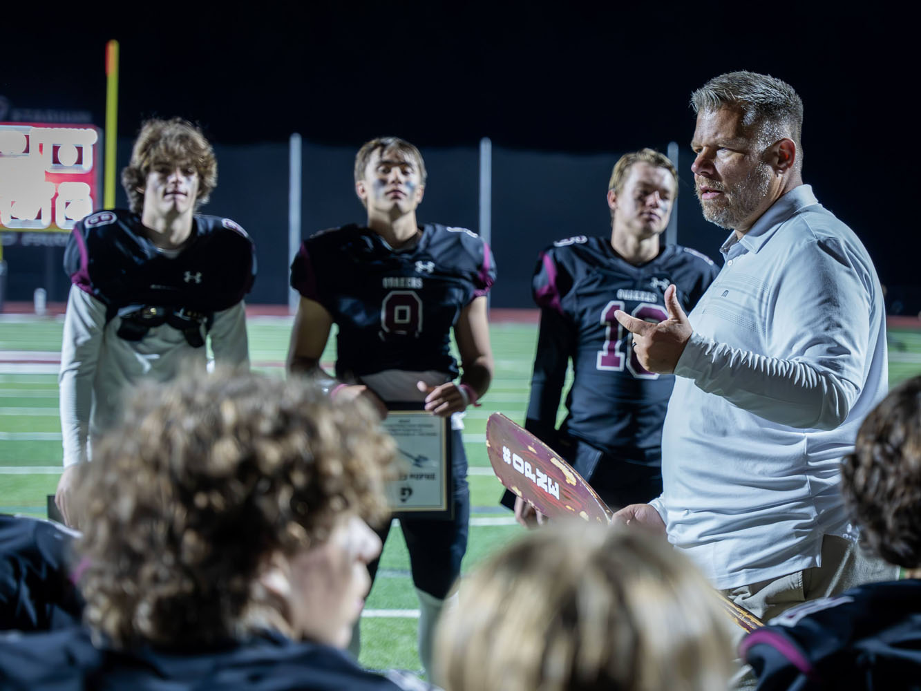 Coach talking to his team after a win Coach talking to his team after a win