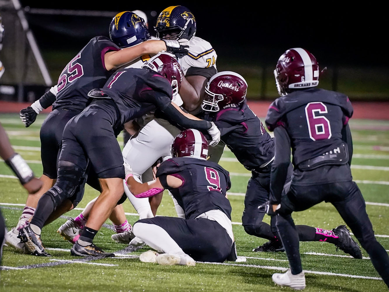 A gang of Quakers making the tackle against Niagara Falls A gang of Quakers making the tackle against Niagara Falls