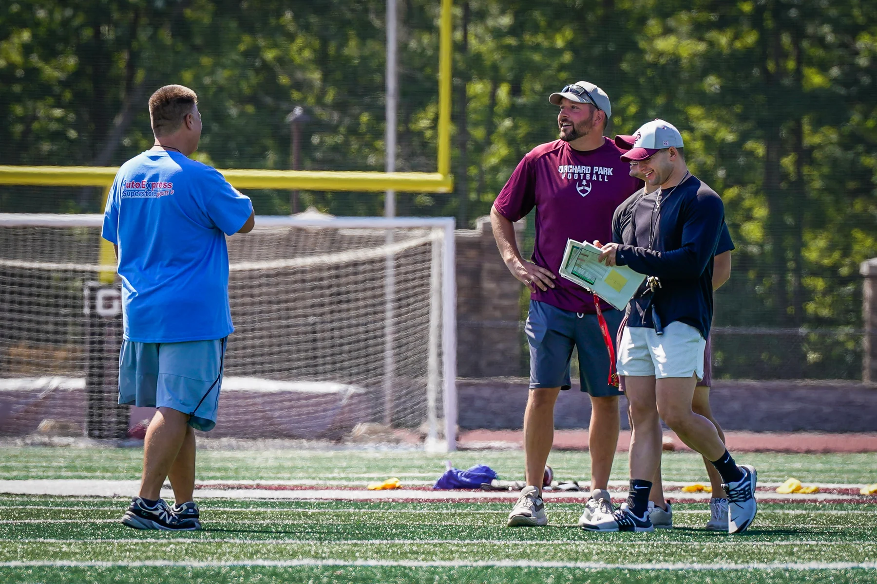 Coaches smiling during practice