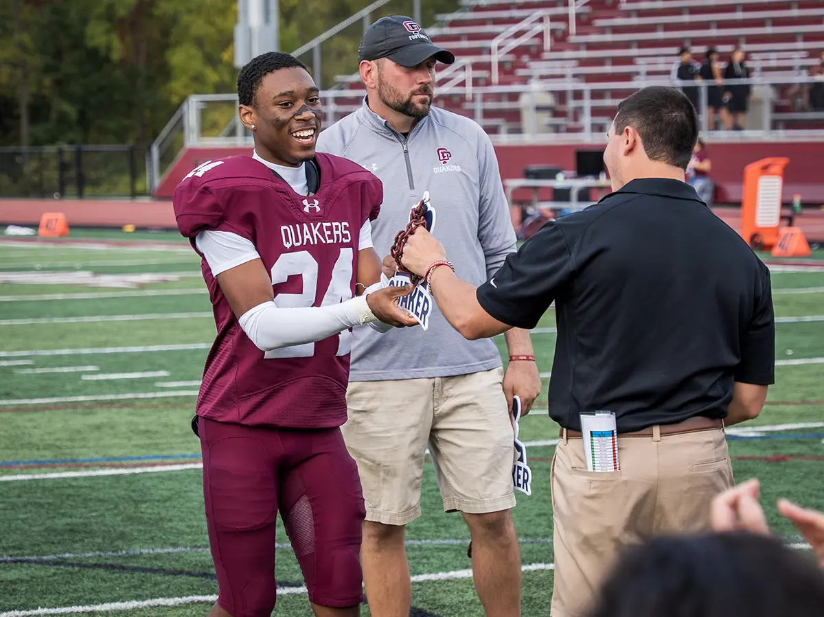 Coach handing out the hardware