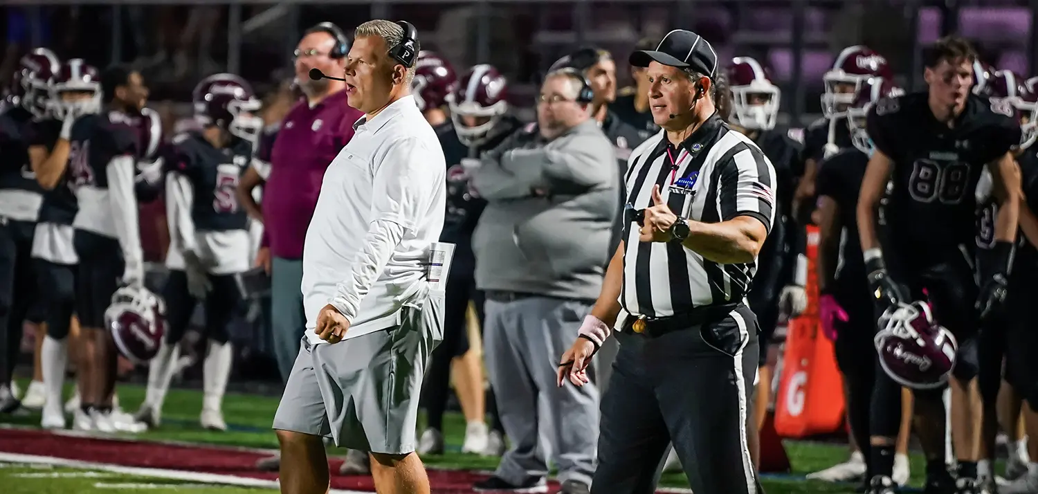 Coach on the field with a Referee